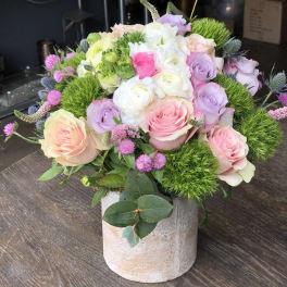 Pastel rose bouquet in a stone vase