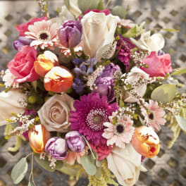 Colorful bouquet with roses, tulips, and daisies