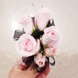 Small corsage with pale pink roses and black ribbon