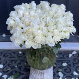 Large bouquet of white roses in a glass vase