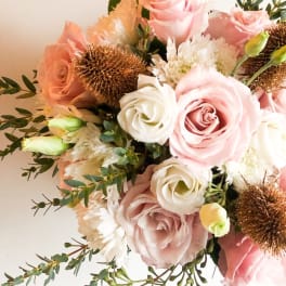 Bouquet of pale pink and white roses with white blooms and bronze accents