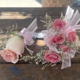Pink rose boutonniere and matching rose wrist corsage with ribbon