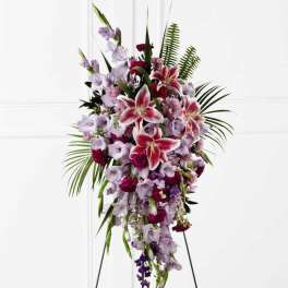 Standing floral spray with pink lilies and lavender flowers on an easel
