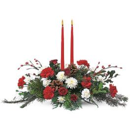 Red and white floral centerpiece with two tall red candles