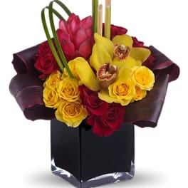 Bouquet of red and yellow roses with orchids in a black vase