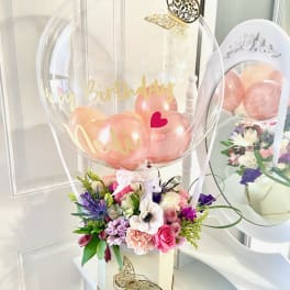 Birthday balloon arrangement with flowers in a decorative box