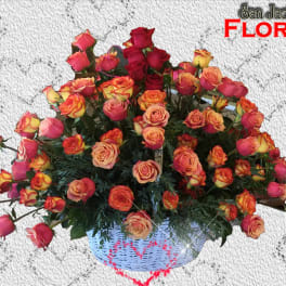 Basket of multicolored roses with pink and orange blooms