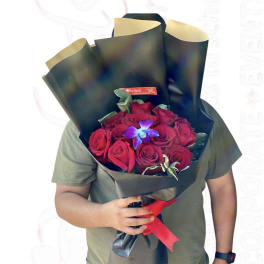 Bouquet of red roses wrapped in black paper with a red ribbon