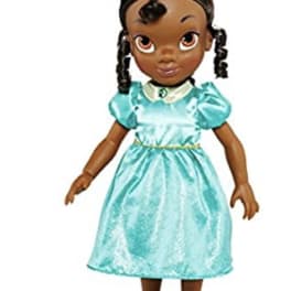 A doll wearing a turquoise dress and black shoes