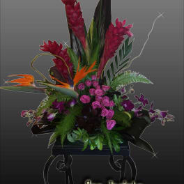 Tropical floral arrangement with pink roses and orange bird-of-paradise