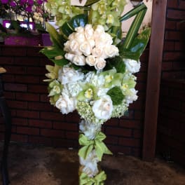 Tall floral standing spray with white roses and green orchids