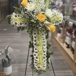 Cross-shaped floral standing spray with white daisies and yellow roses