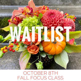 Fall floral arrangement with pumpkins, roses, and dahlias
