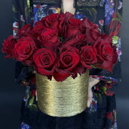 Bouquet of red roses in a gold textured vase