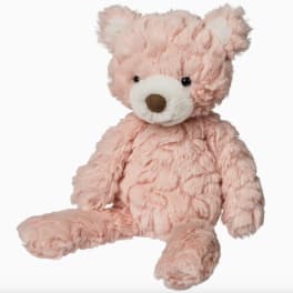 Pink plush teddy bear with a white snout and brown nose
