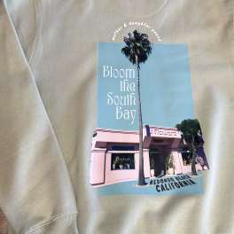 Beige sweatshirt with a printed flower shop graphic and palm trees
