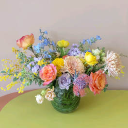 Mixed bouquet of colorful flowers in a glass vase