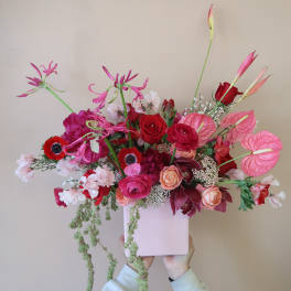 Pink and red floral arrangement in a pale pink box
