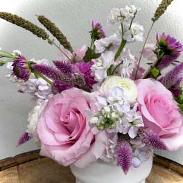 Pink and white floral arrangement in a white vase