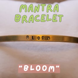 Gold bracelet engraved with the word Bloom