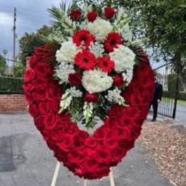 Heart-shaped standing floral tribute with red and white flowers
