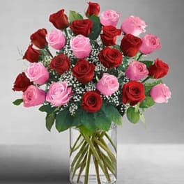 Bouquet of red and pink roses in a clear glass vase
