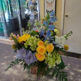 Colorful mixed flower arrangement in a copper vase