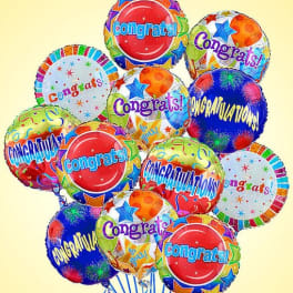 Cluster of colorful congratulatory balloons with star patterns