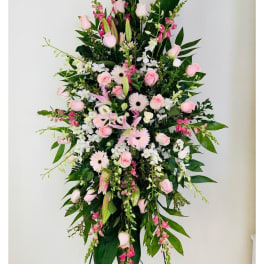 Tall pink and white floral standing spray on an easel