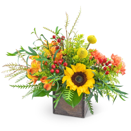 Sunflower and orange floral arrangement in a wooden cube vase