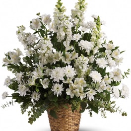 White floral arrangement in a woven basket