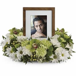 Framed photo surrounded by white and green flowers
