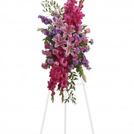 Tall pink and purple floral standing spray on an easel