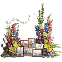 Floral photo frame display with colorful flowers around multiple picture frames
