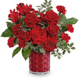 Red roses and carnations in a red heart-patterned vase