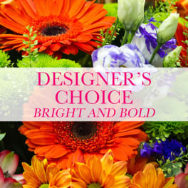 Bright mixed flowers with large orange gerberas and purple blooms behind text