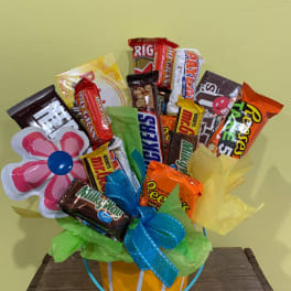 Candy bouquet in a striped bucket with a flower-shaped topper