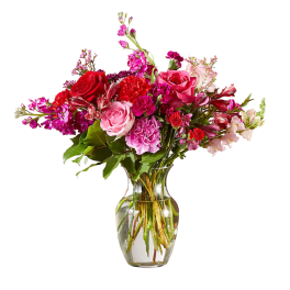 Mixed pink and red flower bouquet in a clear glass vase