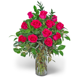 Pink roses arranged in a clear glass vase