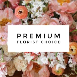 Mixed pastel flower arrangement with a "Premium Florist Choice" sign