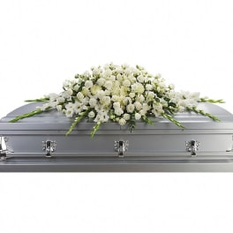 White floral spray on a silver casket