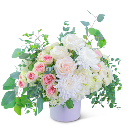 White and blush roses with white chrysanthemums in a white vase
