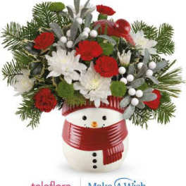 Holiday bouquet in a snowman container with red and white flowers