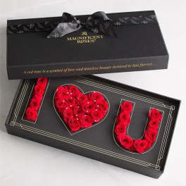 Black gift box with red roses arranged to spell I love you