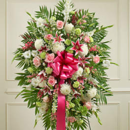 Standing floral spray with pink and white flowers and a bright pink ribbon
