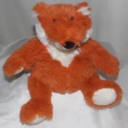 Orange and white stuffed fox toy sitting upright