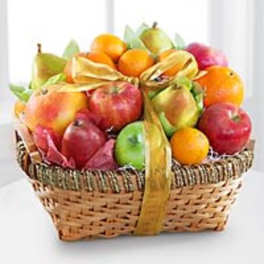 Basket of assorted fruit tied with a gold ribbon