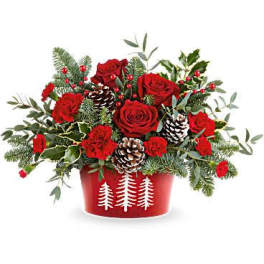 Red roses and carnations in a red container with pinecones