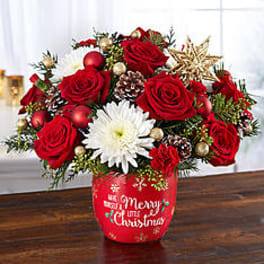Red roses and white daisy bouquet in a red Christmas container