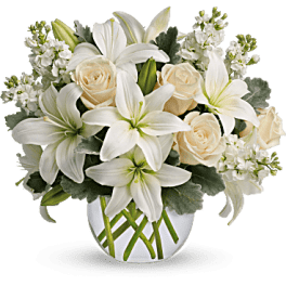 White lilies and cream roses in a white vase